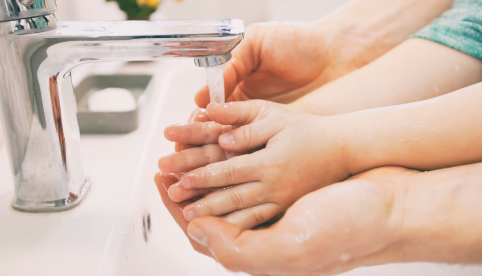 two sets of hands being washed