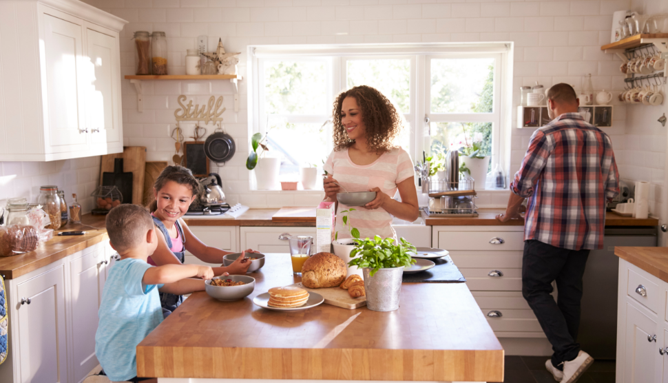 Family-At-Home-Eating-Breakfast-In-Kitchen-Together (1)