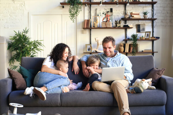 Young beautiful happy family relaxing at home