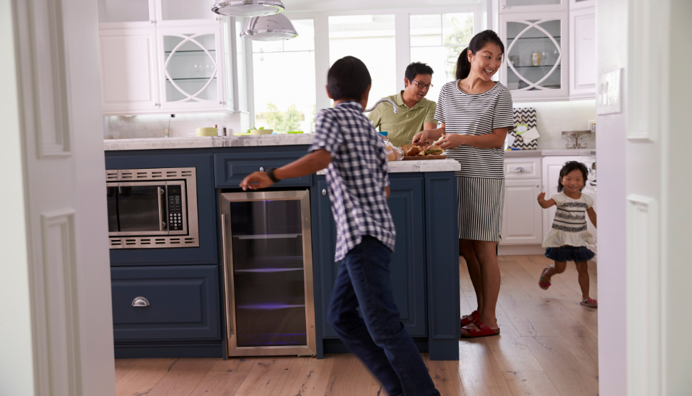 Parents-Prepare-Food-As-Children-Play-In-Kitchen